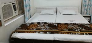 Ένα ή περισσότερα κρεβάτια σε δωμάτιο στο International Guest House