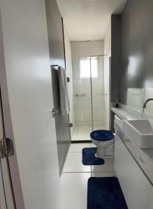 a bathroom with a toilet and a sink and a shower at Apartment COP30 in Ananindeua