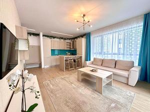 a living room with a couch and a table at Marcony Seaview Apartments in Mamaia