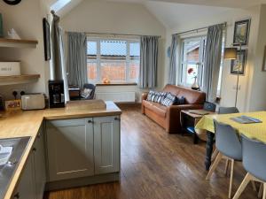 a kitchen and living room with a couch and a table at Oiseval in Fort Augustus