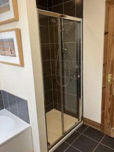a shower with a glass door in a bathroom at Oiseval in Fort Augustus +21 photos