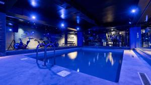 a swimming pool in a building with a gym at MIRANDA HOTEL - Tanger in Tangier
