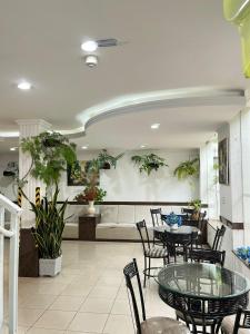 a dining room with a glass table and chairs at Hotel Lux in Poços de Caldas +38 photos