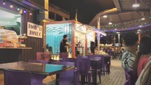 a man standing in front of a stage with a microphone at Watermelon Hotel in Miri