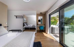 a bedroom with a bed and a view of a bathroom at Villa Palazzo Maestral beachfront by Villas Guide in Viniština +66 photos