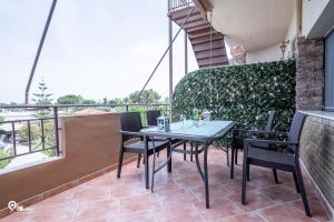 a patio with a table and chairs on a balcony at The Seagull - Quiet Retreat With Panoramic View in Nea Makri in Nea Makri +43 photos