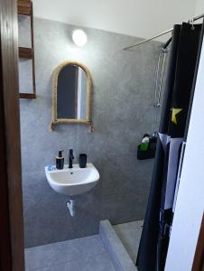 a bathroom with a sink and a mirror at B&B Casa Boho in Telha +60 photos