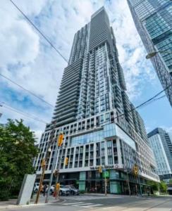 a tall building on a city street with at Cozy holiday home in Toronto