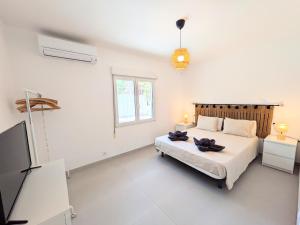 a bedroom with a bed and a flat screen tv at R-70 Oasis in Ciudad Quesada +36 photos