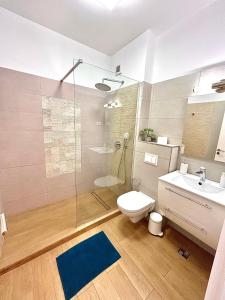 a bathroom with a shower and a toilet and a sink at Marcony Seaview Apartments in Mamaia +119 photos