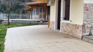 a patio in front of a house at pavliani house in Pávliani