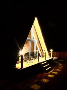 a house at night with lights on the porch at Lunascape in Sîntimbru-Băi