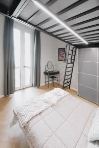 a large bed in a room with a ladder at Mole Turin Suite in Turin