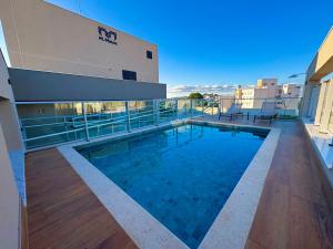 a swimming pool on the roof of a building at Tupis Flats 1401 in Belo Horizonte