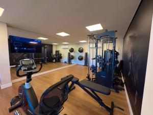 a room with a gym with a treadmill and a exercise bike at Tupis Flats 1401 in Belo Horizonte