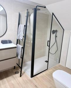 a shower with a glass door in a bathroom at Nuevo, Verde y Acogedor in El Castellar