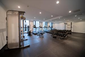 a gym with rows of treadmills and exercise bikes at Xihe Langyue Hotel Beijing Changying Tianjie Branch in Beijing