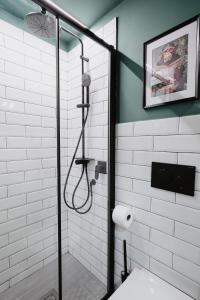 a bathroom with a shower with a glass door at Mole Turin Suite in Turin +25 photos