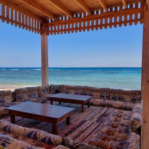 a living room with a couch and tables on the beach at Shakazola Camp in Nuweiba +39 photos