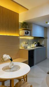 a kitchen with a white table and a counter top at Cozy Nook at JTower Residences in Mandaue City +4 photos