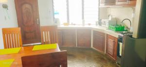 a kitchen with a table and a counter top at Guestroom in Malindi