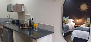 a bathroom with a counter with a sink and a mirror at EveGreen Guest Lodge in Derby +9 photos
