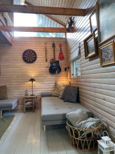 a living room with a couch in a wooden wall at Wonderful Family Vacation Home in Ågerup