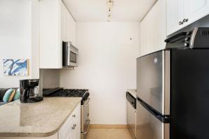 ニューヨークにあるLovely and Comfy Studio in NYCのキッチン(冷蔵庫、カウンタートップ付)