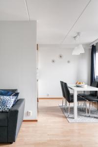 een woonkamer met een tafel en stoelen bij Spacious City Retreat with Private Sauna in Helsinki