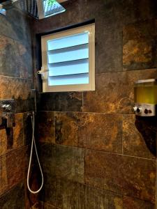 a window in a bathroom with a shower at Cozy House with Terrace in Upper Prince's Quarter in Upper Prince's Quarter +26 photos