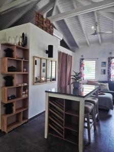 a living room with a table and a couch at Cozy House with Terrace in Upper Prince's Quarter in Upper Prince's Quarter