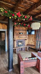 a living room with a fireplace and flowers on the ceiling at Файно in Beloberëzka