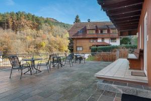 a patio with tables and chairs and a house at Vogtadeshof in Wolfach