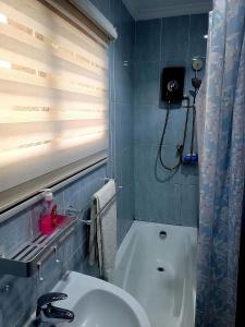 ein Badezimmer mit einem weißen Waschbecken und einer Dusche in der Unterkunft Ghouse room D Ideal For Friends family And Corporate in Lateman