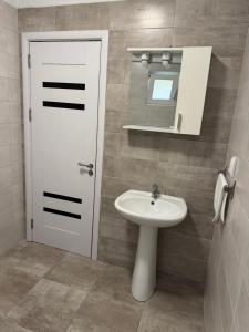 a bathroom with a white sink and a mirror at illy apartament in Craiova