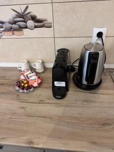 a toaster and coffee maker sitting on a kitchen counter at illy apartament in Craiova +5 photos