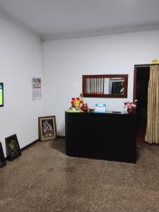 a living room with a table and some pictures at Wandana Holiday Home in Anuradhapura +2 photos