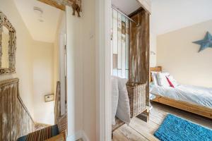 a small bedroom with a bed and a window at Sunset View in Thornham