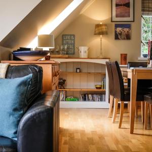 a living room with a couch and a table at Tanar View in Aboyne