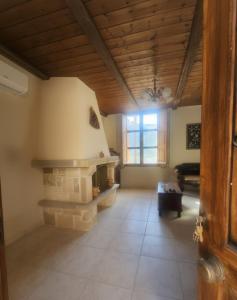 a living room with a stone fireplace in a house at Horizon Giouchtas View Archanes Home in Archanes