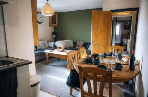 a kitchen and living room with a table and a couch at The Hideaway in Stratford-upon-Avon