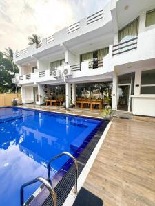 a swimming pool in front of a building at OLA Tangalle in Tangalle