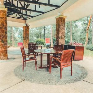 a patio with a table and chairs on a patio at Insta-Worthy Swiss House Crosswinds Tagaytay in Tagaytay