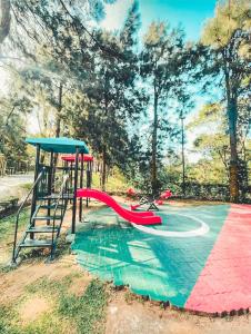 a playground with a slide and a play structure at Insta-Worthy Swiss House Crosswinds Tagaytay in Tagaytay