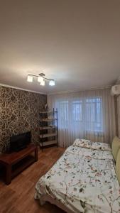 a bedroom with a bed and a book shelf at Апартаменти біля Автовокзалу in Kryvyi Rih