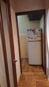 a kitchen with a refrigerator in a room at Апартаменти біля Автовокзалу in Kryvyi Rih