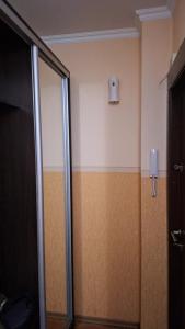a bathroom with a glass shower door and a wall at Апартаменти біля Автовокзалу in Kryvyi Rih