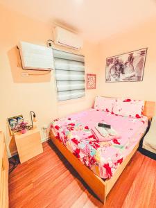 a bedroom with a bed with a floral bedspread at Insta-Worthy Swiss House Crosswinds Tagaytay in Tagaytay +72 photos