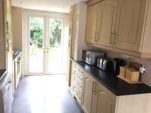 a kitchen with a counter top with a microwave at chesterton Grove in Manchester