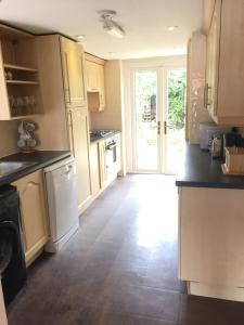 a kitchen with an open door to a yard at chesterton Grove in Manchester +5 photos